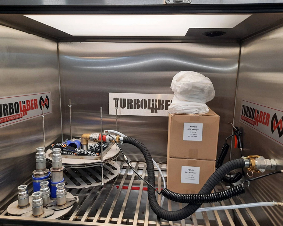 Inside the TurboLaber DPF cleaning machine showing the internal cleaning chamber and equipment setup.