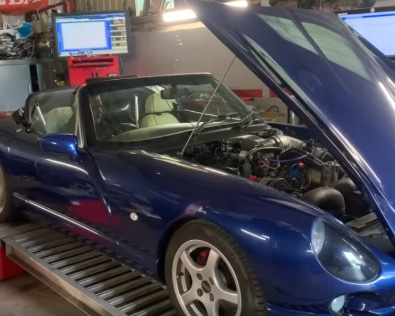 Performance car on rolling road dyno with bonnet open during engine tuning and power testing at Murray Motorsport.