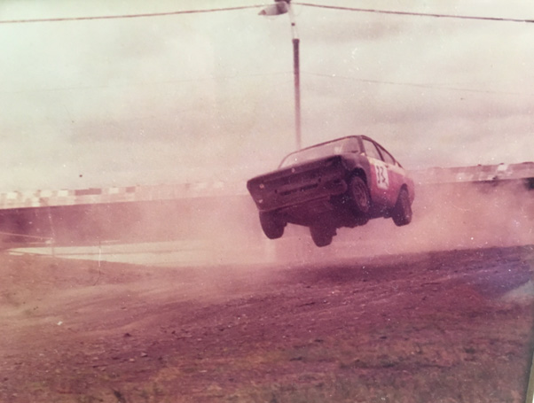 Archive photo of Tommy Murray (Senior) rallying, with the car airborne on a dirt track.